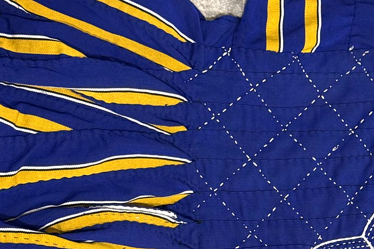 Royal-blue bodice with gold and cream warp stripes and white diamond hand-stitching on a Presidential Elite Blue & Gold fugu smock