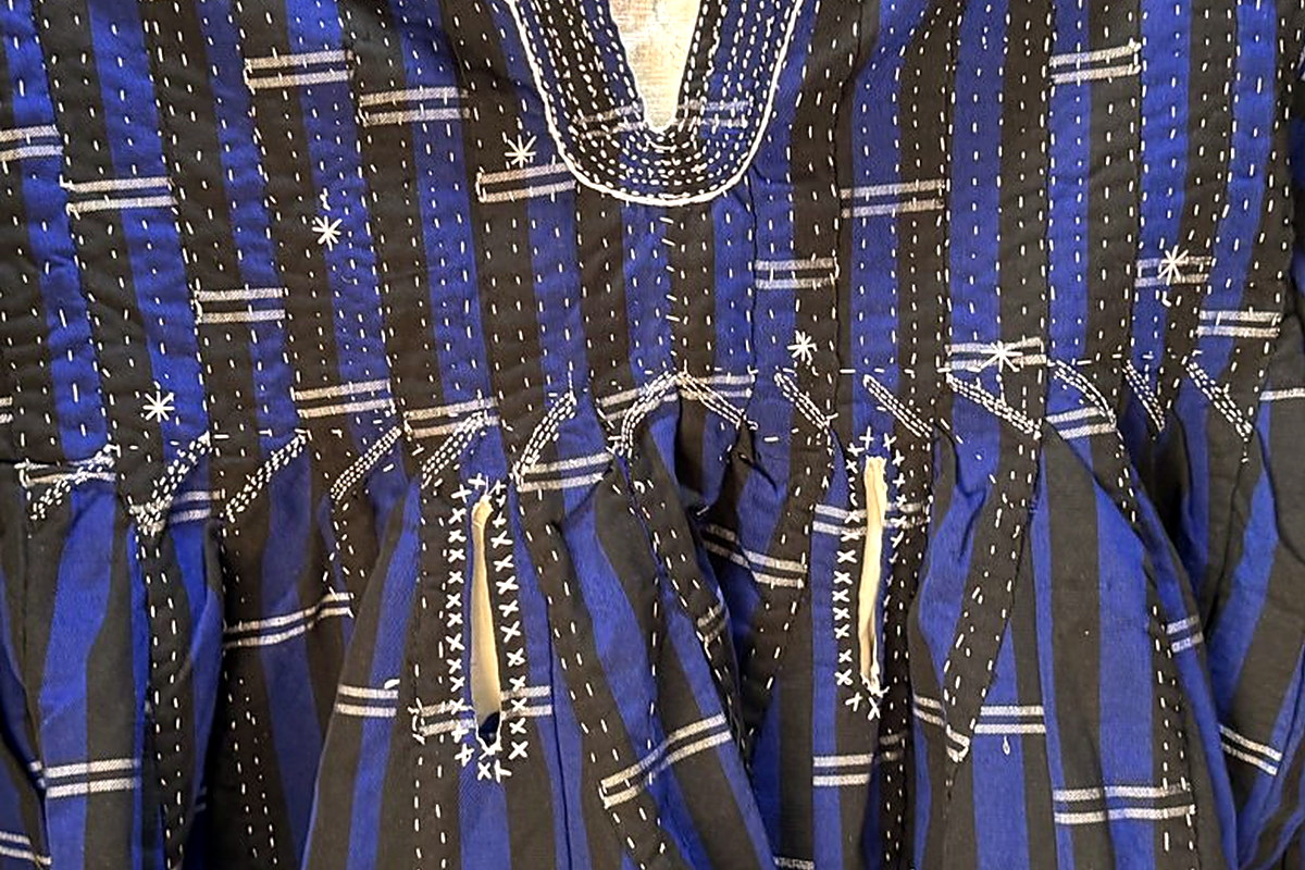 Indigo and dark-brown alternating warp stripes with white weft dashes on a hand-woven Navy Blue fugu smock